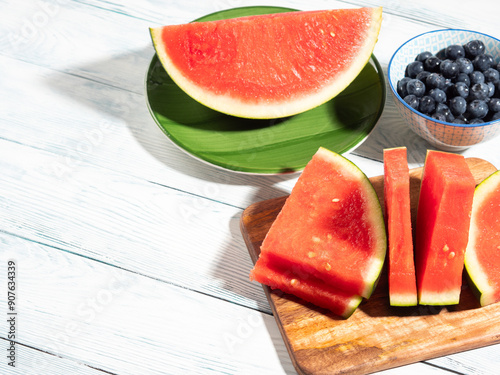 Seedless watermelon and blueberries on wooden background, summer fruit