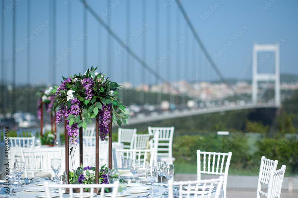 Elegant Outdoor Wedding Reception with Purple and White Floral Centerpieces
