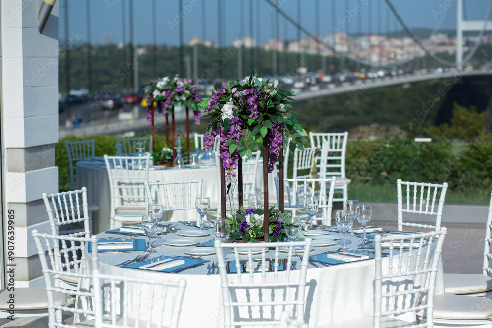 Elegant Outdoor Wedding Reception with Purple and White Floral Centerpieces