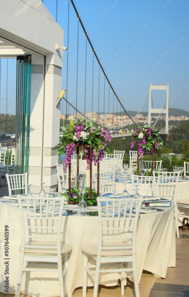 Elegant Outdoor Wedding Reception with Purple and White Floral Centerpieces