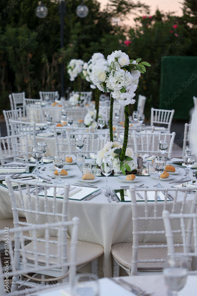 Elegant Indoor Wedding Reception with White Floral Centerpieces and Mirror Chargers