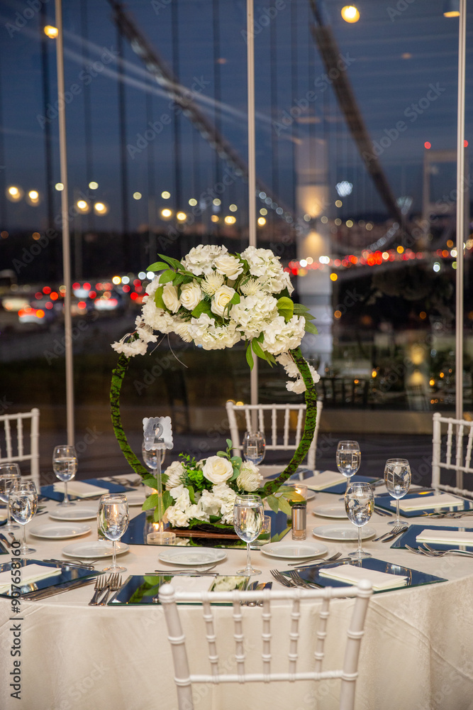Charming Indoor Wedding Table Arrangement with White Decor and Night Cityscape