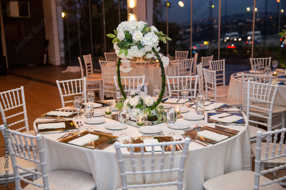 Charming Indoor Wedding Table Arrangement with White Decor and Night Cityscape