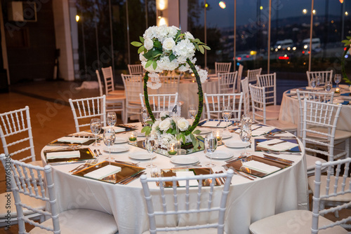 Obraz na płótnie Charming Indoor Wedding Table Arrangement with White Decor and Night Cityscape w salonie