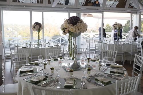 Elegant Wedding Venue with Floral Centerpieces and White Chairs