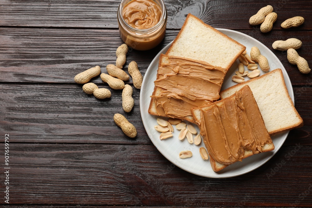 Delicious sandwiches with peanut butter and nuts on wooden table, flat lay Delicious sandwiches with peanut butter and nuts on wooden table, flat lay