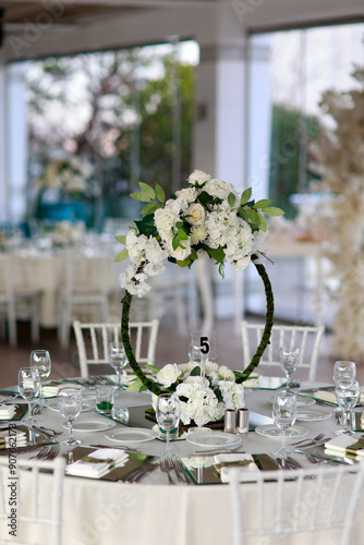 Obraz na płótnie Indoor Wedding Setup: Round Tables and Floral Decor in White and Green w salonie