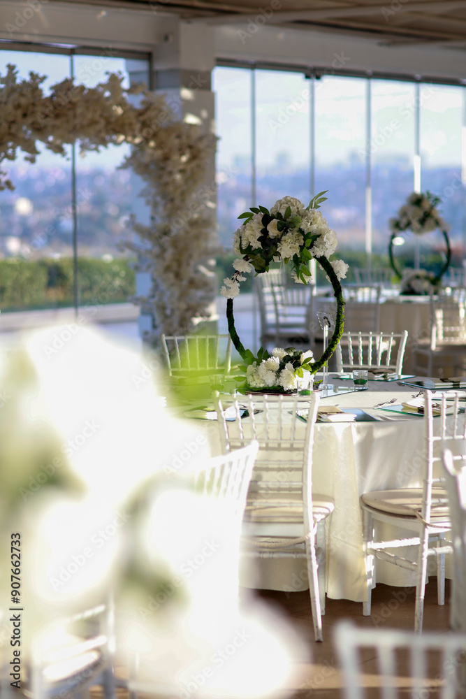 Elegant Wedding Venue with Floral Centerpieces and White Chairs
