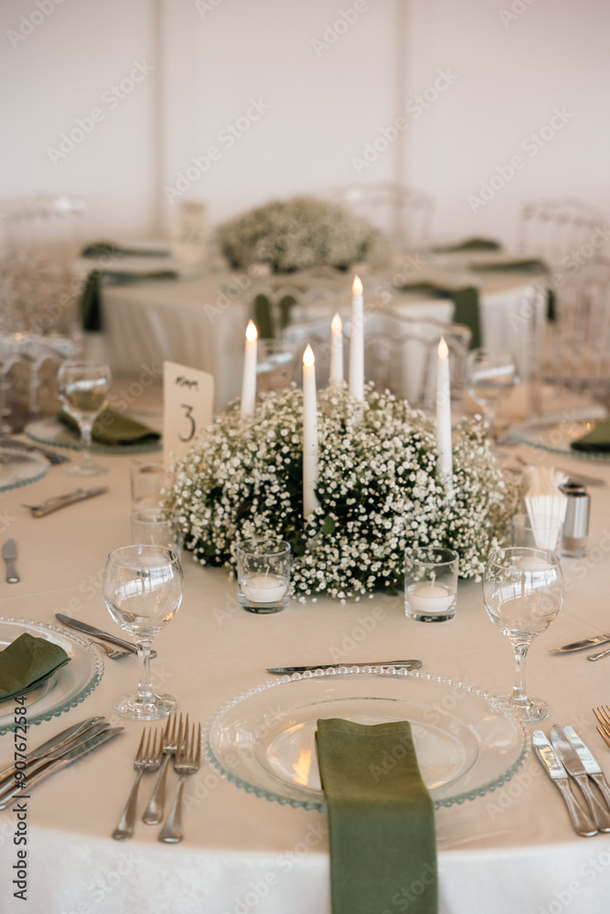 Romantic reception table with floral centerpiece and soft candlelight