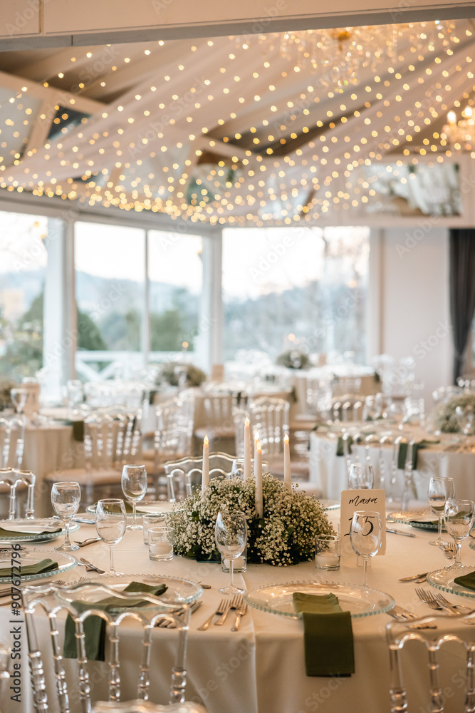 Romantic reception table with floral centerpiece and soft candlelight
