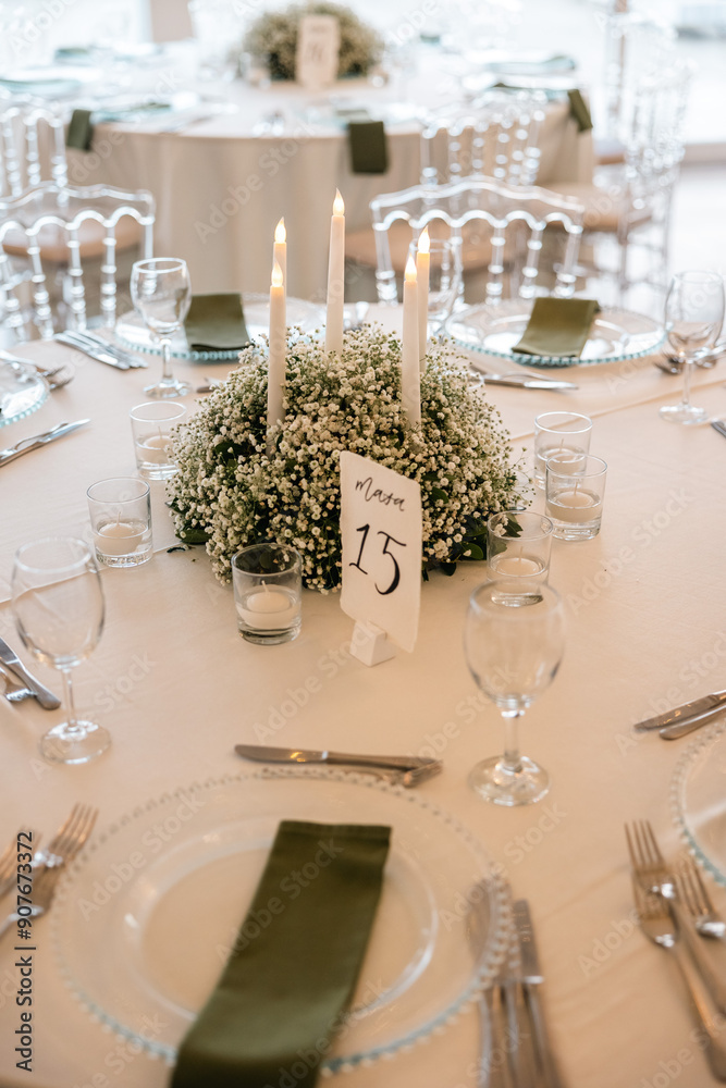 Romantic reception table with floral centerpiece and soft candlelight