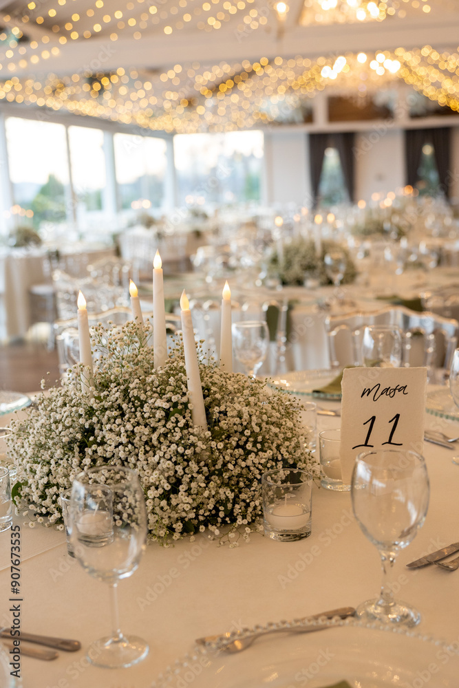 Romantic reception table with floral centerpiece and soft candlelight