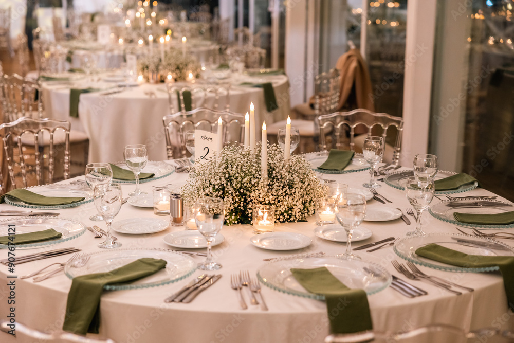 Romantic reception table with floral centerpiece and soft candlelight