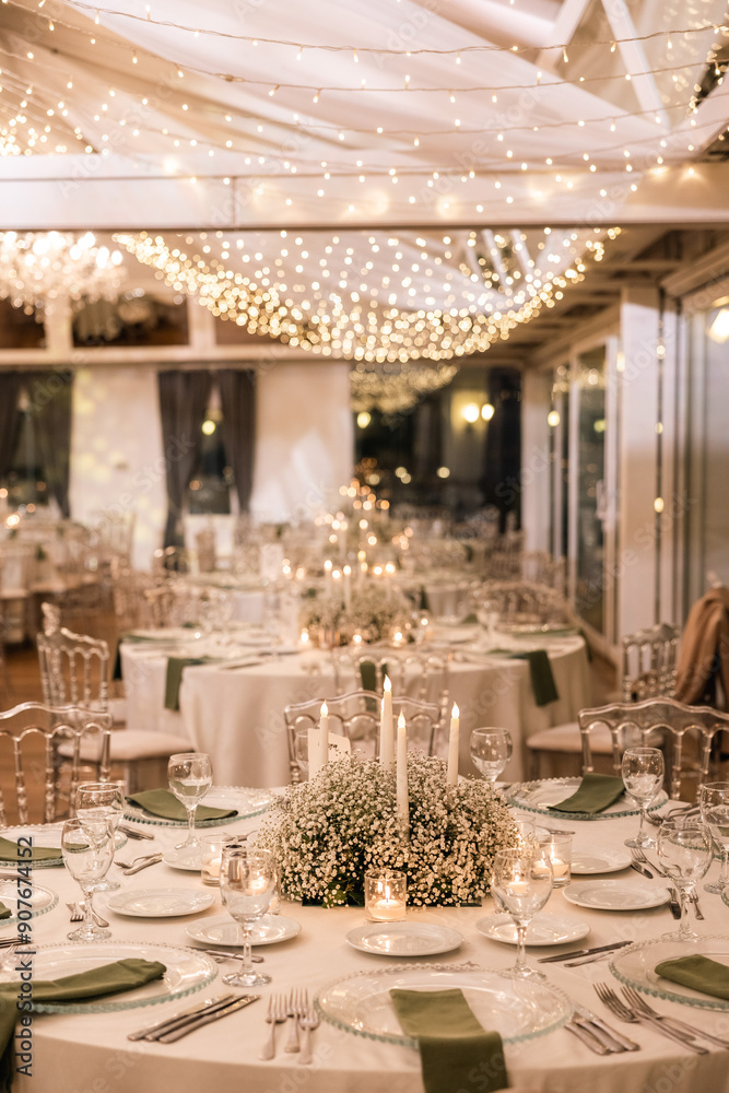Romantic reception table with floral centerpiece and soft candlelight