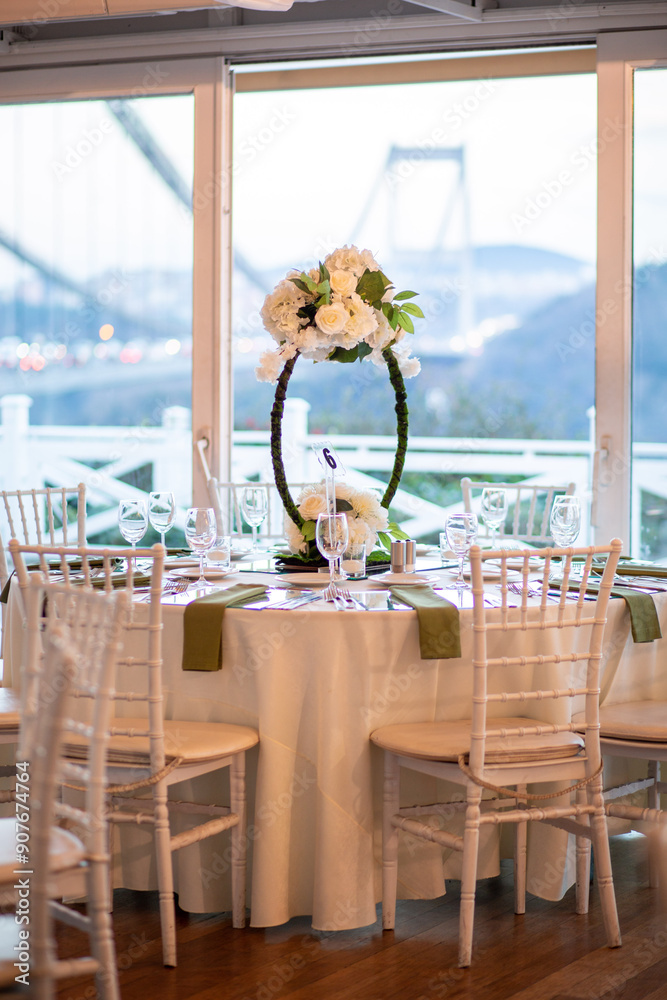 Luxurious dining arrangement near Bosphorus Bridge with white roses and modern decor