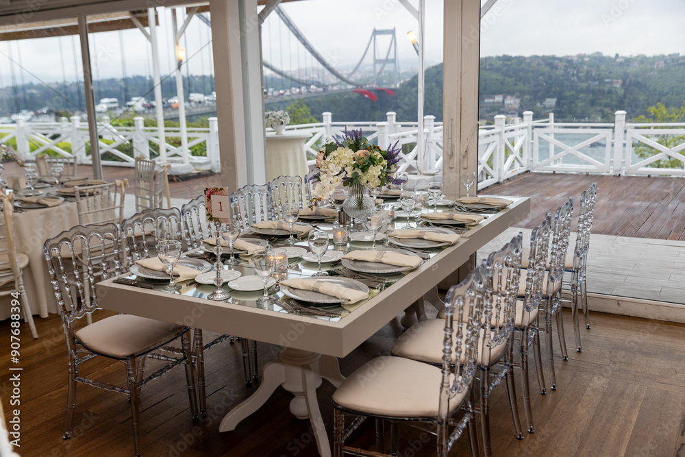 Stylish Outdoor Reception: Lounge Furniture with Floral Accents and Urban Panorama