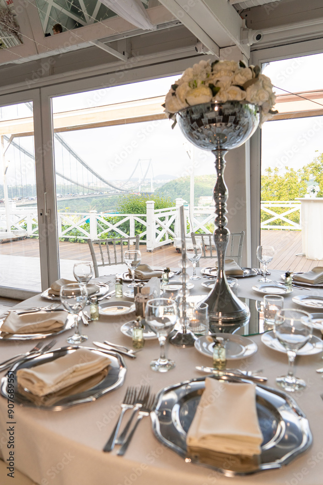 Stylish Outdoor Reception: Lounge Furniture with Floral Accents and Urban Panorama