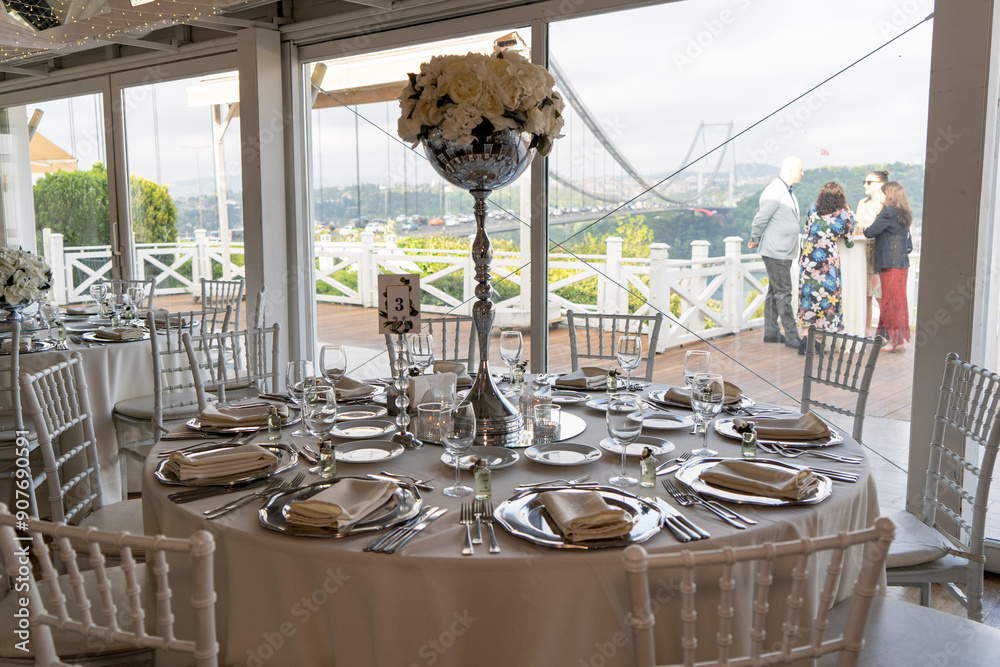 Stylish Outdoor Reception: Lounge Furniture with Floral Accents and Urban Panorama