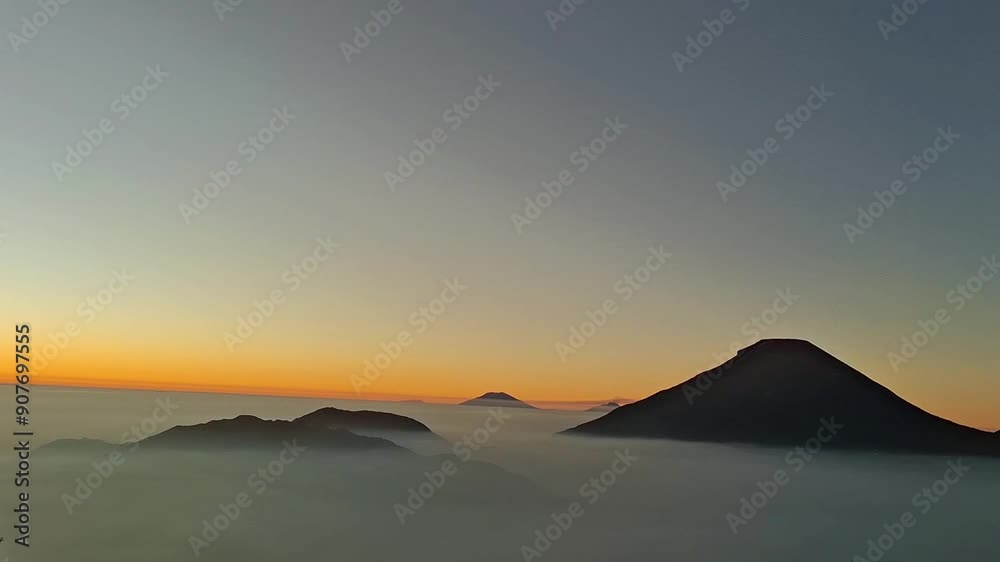 Sunrise over the mountain. Sunrise view of the Dieng plateau. with a beautiful sky color covered with clouds with an altitude of about 2,093 meters above sea level, Central Java, Indonesia.