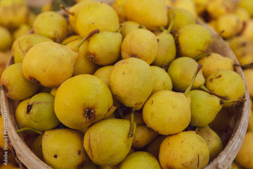 Yellow pears in a basket on the counter of a farmers market. Yellow pears in a basket on the counter of a farmers market.