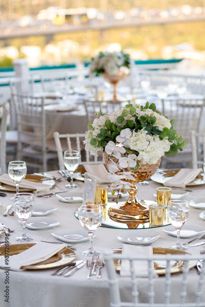 Minimalist wedding table setting with white linens, gold accents, and greenery, perfect for a modern outdoor wedding Minimalist wedding table setting with white linens, gold accents, and greenery, perfect for a modern outdoor wedding