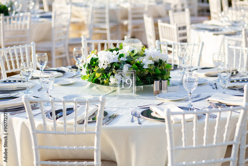Elegant Wedding Table with White Flowers and Greenery at Outdoor Reception