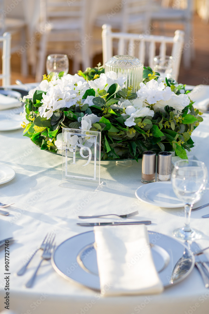 Elegant Wedding Table with White Flowers and Greenery at Outdoor Reception