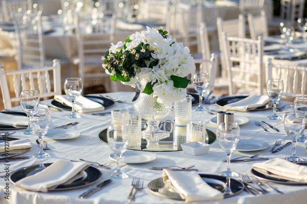 Elegant Wedding Table with White Flowers and Greenery at Outdoor Reception