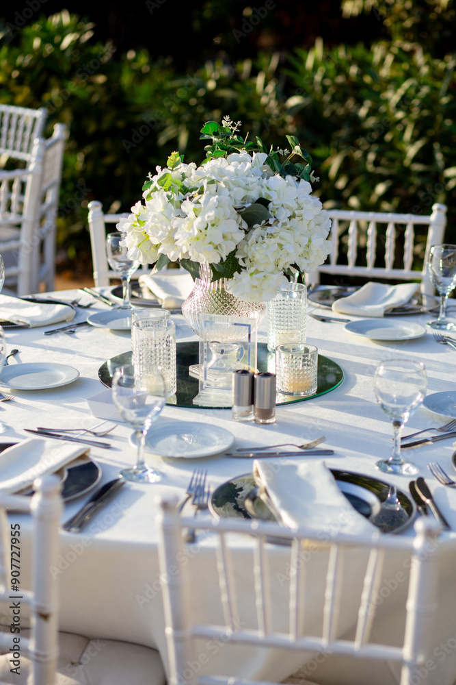 Elegant Wedding Table with White Flowers and Greenery at Outdoor Reception
