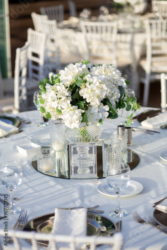 Elegant Wedding Table with White Flowers and Greenery at Outdoor Reception