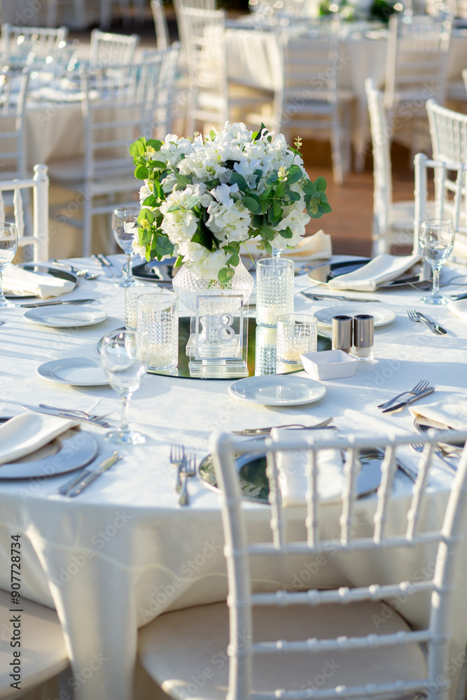Elegant Wedding Table with White Flowers and Greenery at Outdoor Reception