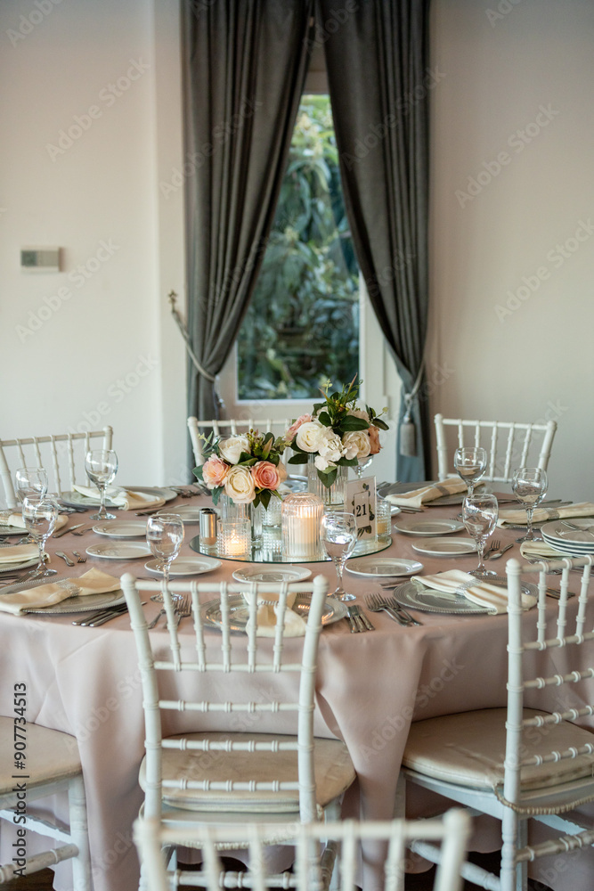 Elegant Wedding Table with Pastel Flowers and Greenery at Indoor Reception