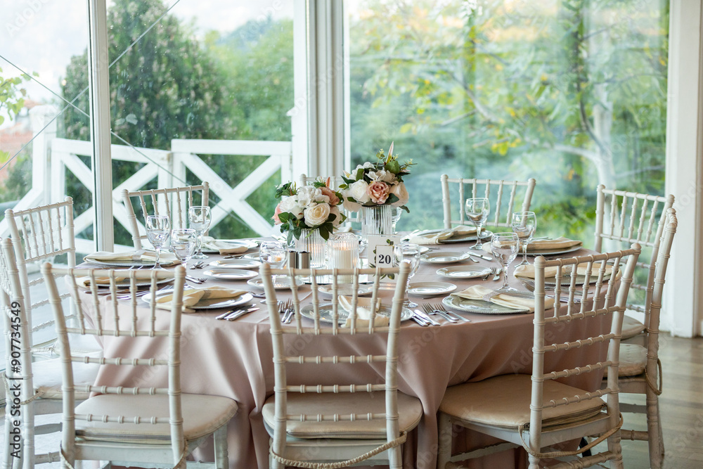 Elegant Wedding Table with Pastel Flowers and Greenery at Indoor Reception