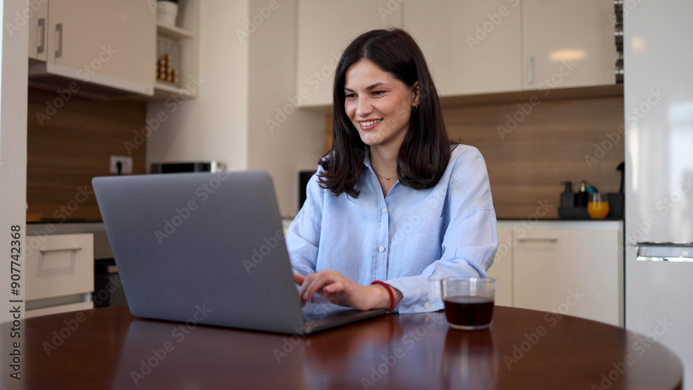 Beautiful woman working on a laptop from her home office Beautiful woman working on a laptop from her home office