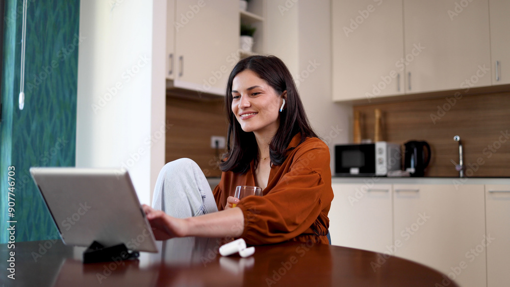 Woman relaxing at home and watching something on a tablet Woman relaxing at home and watching something on a tablet