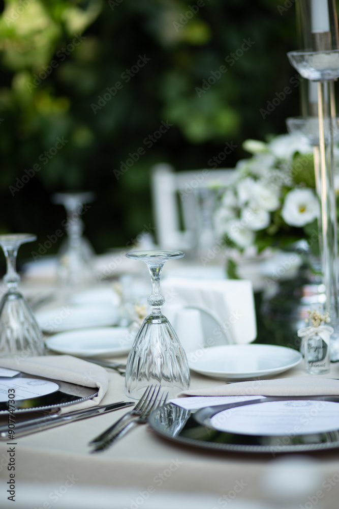 Refined Wedding Reception Table with White Centerpiece and Candlelight Outdoors