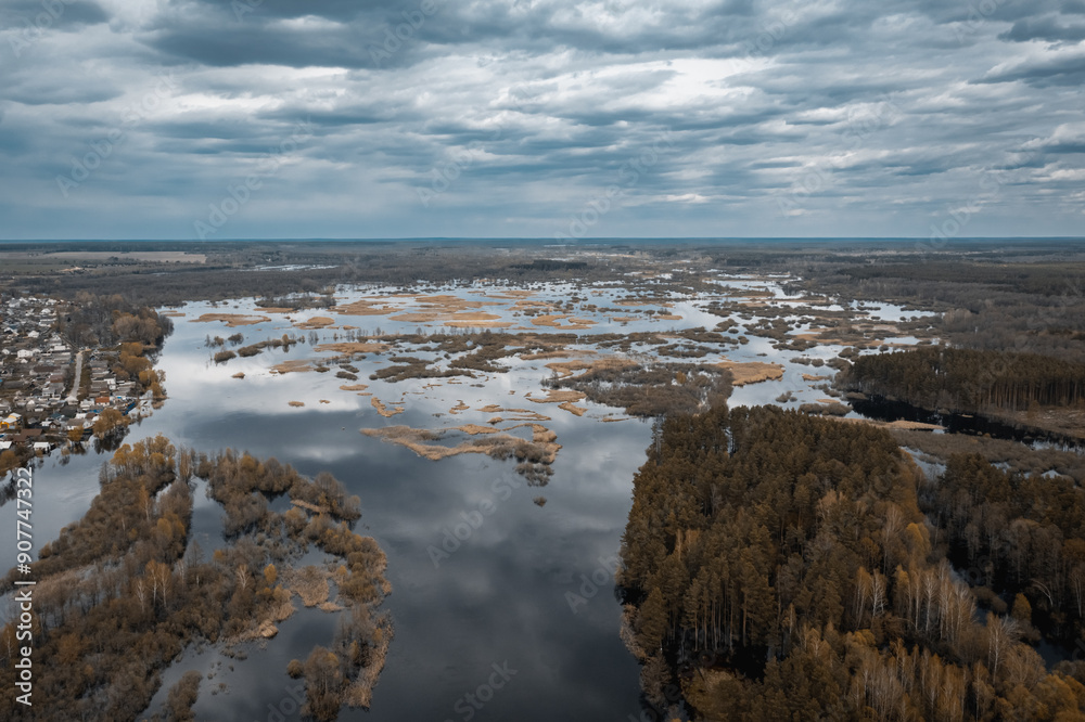 A stunning aerial view of the serene marshlands winding waterways lies under a dramatic, cloudy sky A stunning aerial view of the serene marshlands winding waterways lies under a dramatic, cloudy sky