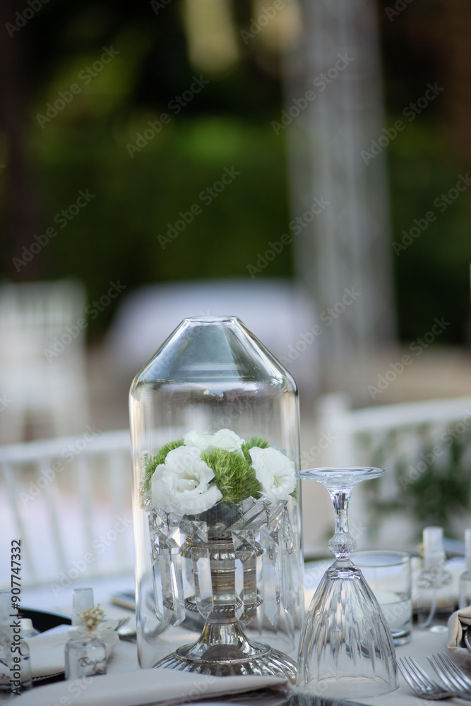 Refined Wedding Reception Table with White Centerpiece and Candlelight Outdoors