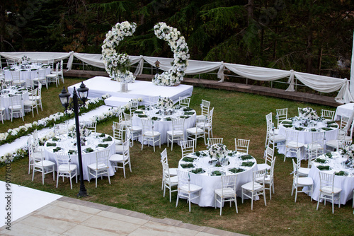Elegant Outdoor Wedding Reception with Wisteria Floral Centerpieces