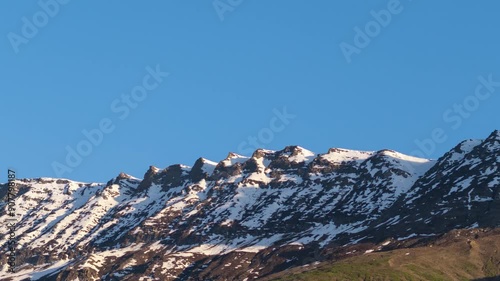 4K Time Lapse shot of the snowy Himalayan mountain peaks during the sunset turning red in colour from white during the sunset as seen from Keylong in Lahaul, Himachal Pradesh, India. Nature background photo