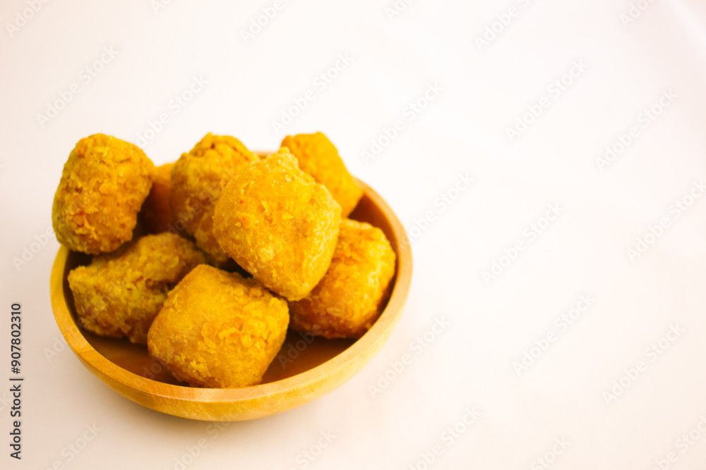 Tahu goreng cripsy, or crispy fried tofu, is one type of snack in Indonesia on wood plate isolated on white background. Perfect for recipe, article, catalogue, commercial, or any cooking contents
Tahu goreng cripsy, or crispy fried tofu, is one type of snack in Indonesia on wood plate isolated on white background. Perfect for recipe, article, catalogue, commercial, or any cooking contents