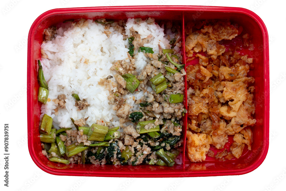 Bright red plastic lunch box with food compartments. Food of Stir-fried minced pork with basil mixed with Morning glory and cut into pieces. Divide in half of Stir-fried Preserved Radish with Egg. Bright red plastic lunch box with food compartments. Food of Stir-fried minced pork with basil mixed with Morning glory and cut into pieces. Divide in half of Stir-fried Preserved Radish with Egg.