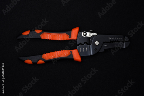 Insulation puller or stripper is an electrical installation tool on a black background.