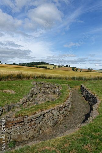 The remains of the Iron age Souterrain of the Ardestie Earth House within fields and gently rolling hills near Dundee. photo