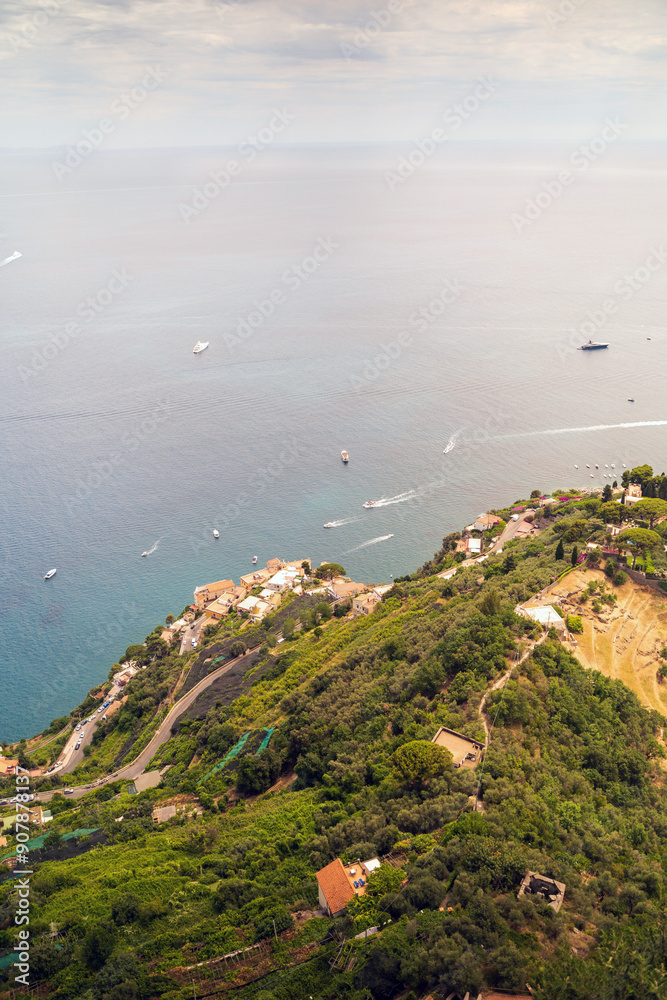 Scenic Aerial View Of Coastal Village With Boats On Tranquil Sea