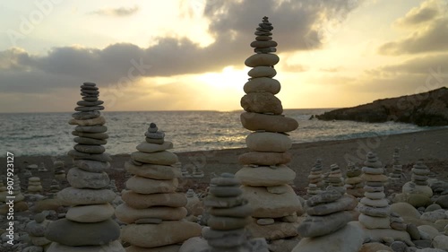Balancing stone, balance tower on the beach, sunset