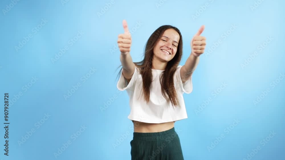 Teenager portrait on blue background, shows thumbs up, cool, young cute emotional student, curly haired adolescent with fun gesture, stylish fashion Teenager portrait on blue background, shows thumbs up, cool, young cute emotional student, curly haired adolescent with fun gesture, stylish fashion