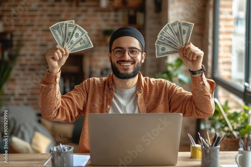 Happy young Muslim man sitting in office in front of laptop, talking on video call, showing and holding fan of money and glasses, bragging about achievement and, Generative AI