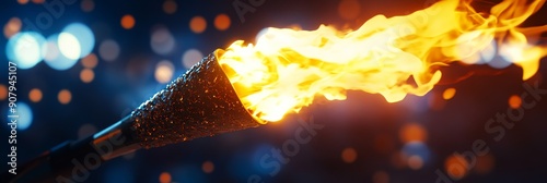 A close-up of a burning torch with a bokeh background. The flames are bright and powerful, symbolizing passion, hope, and strength. The bokeh lights in the background create a sense of energy and exci photo