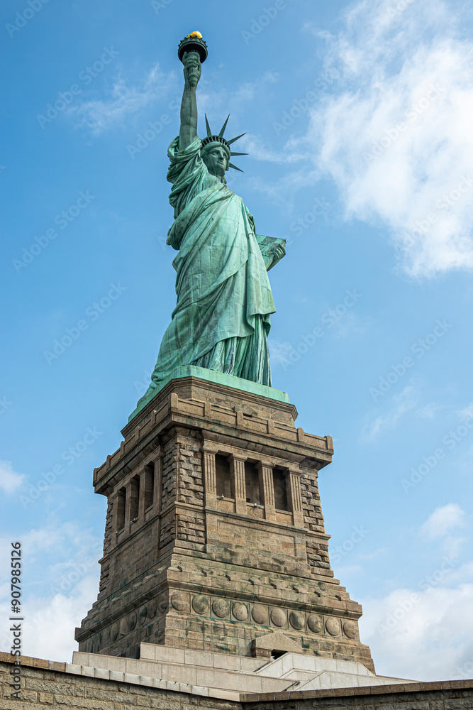 Fototapeta premium New York, NY, USA - August 4, 2023: Miss Liberty statue closeup, against blue sky.